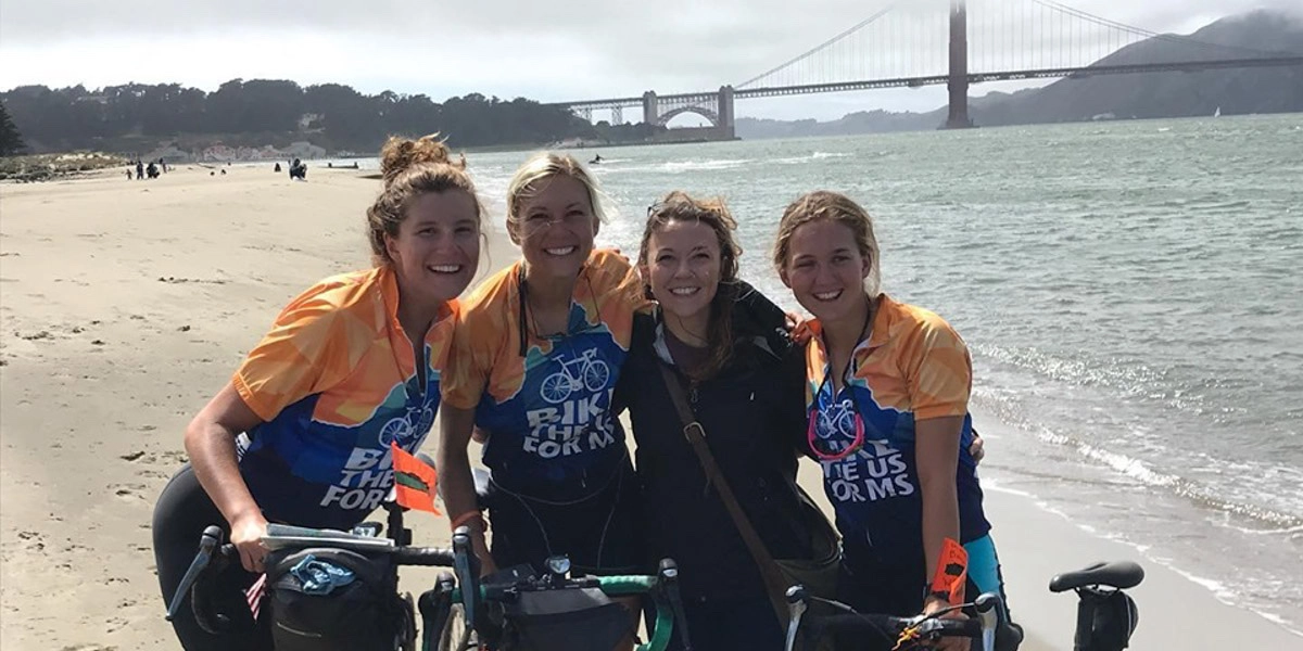 Kaylyn, one of the Route Leaders on the TransAmerica in 2016, celebrating with her team having biked across America.