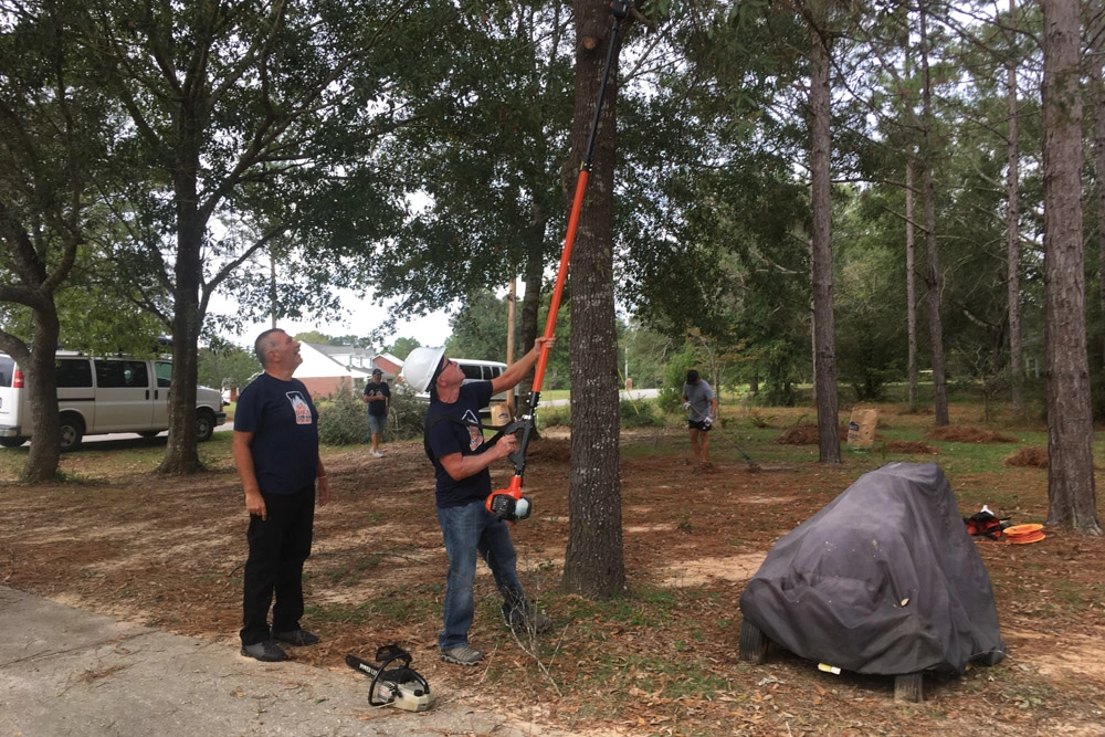 Cutting down tree branches on our service projects.