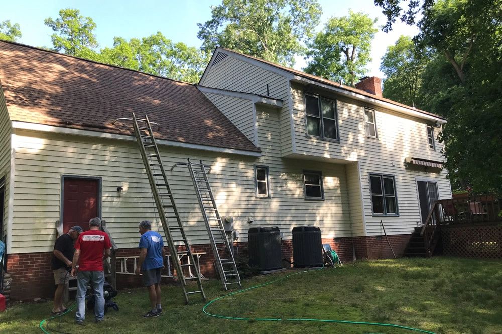 Cleaning up the outside of the house on our service project.